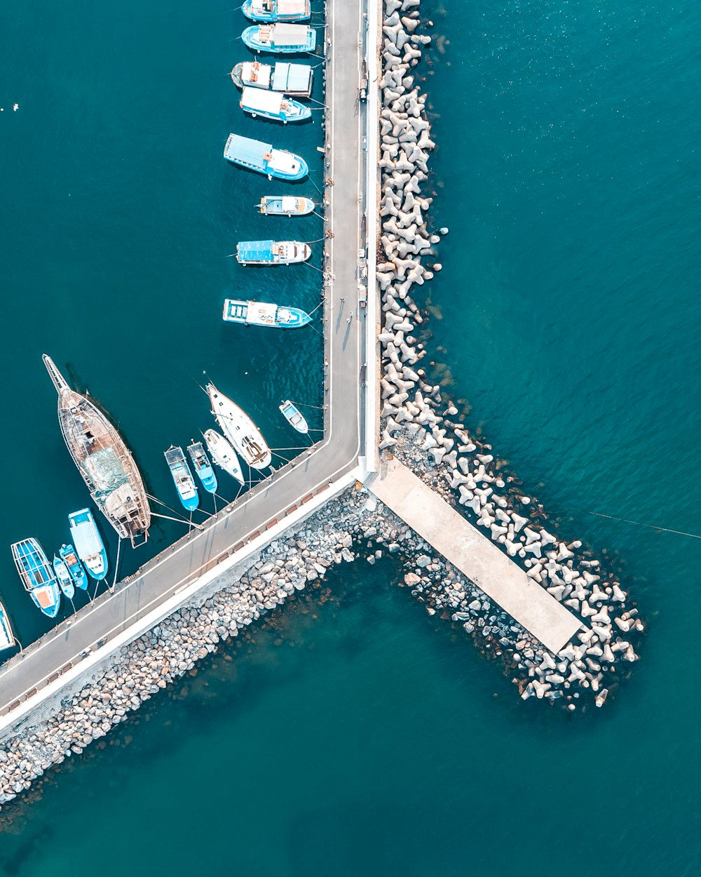 aerial view of white and blue boats on sea dock during daytime