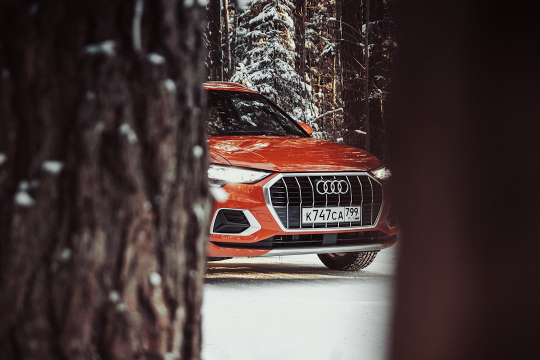 orange audi car on snow covered ground