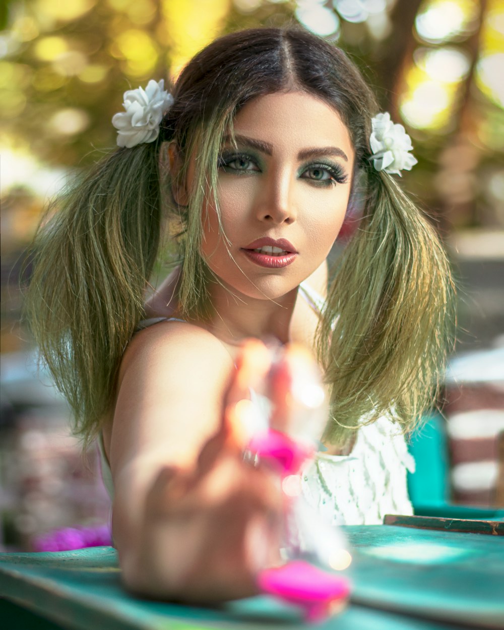 woman in pink tank top with white flower on her ear