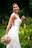 woman in white floral dress holding bouquet of flowers