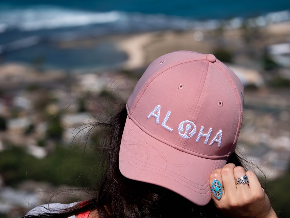 woman in red and white cap