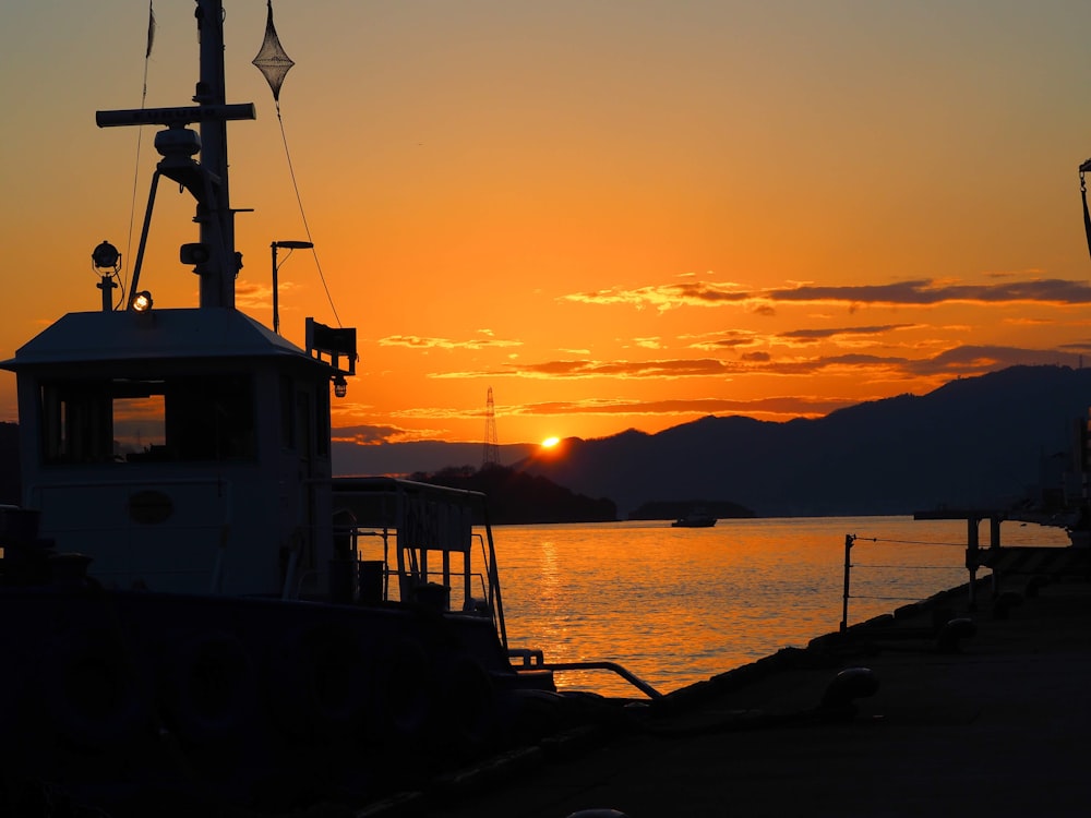 silhouette of people on dock during sunset