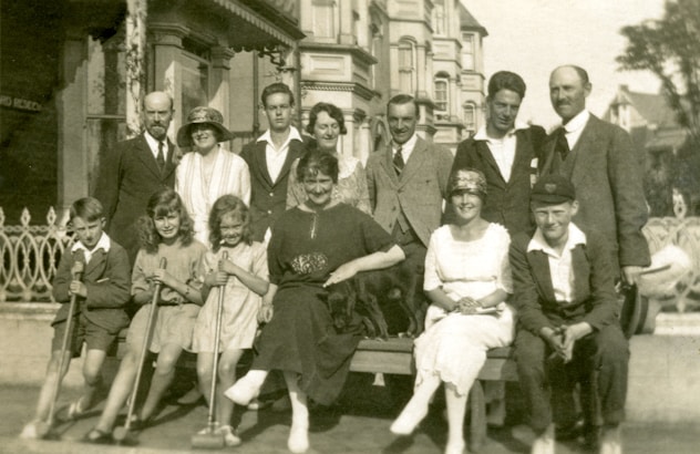 grayscale photo of people standing on road