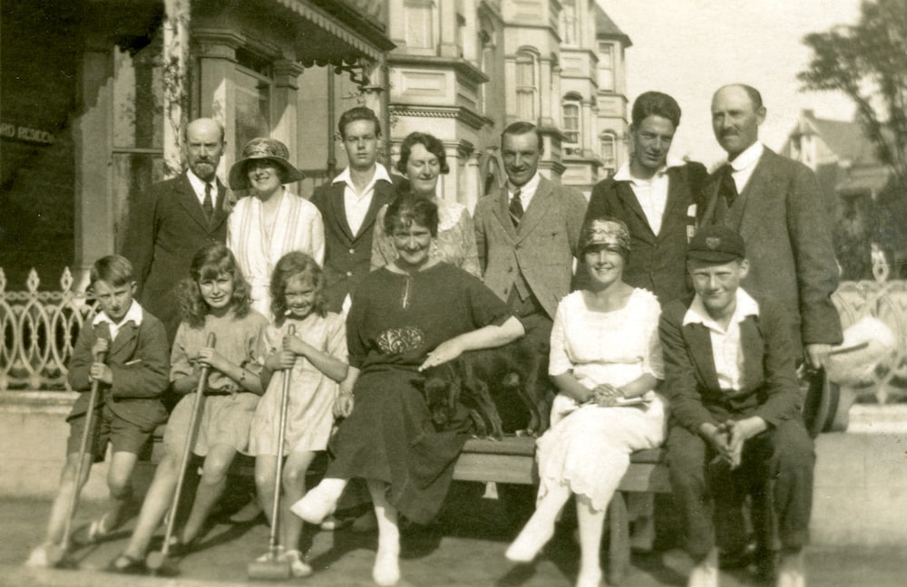 grayscale photo of people standing on road