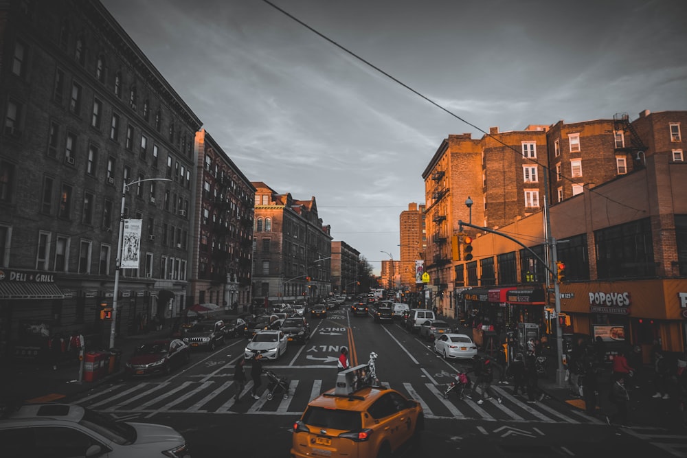 cars parked on street between buildings during daytime