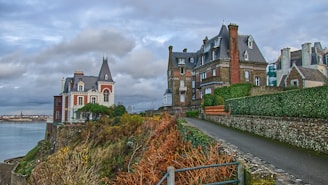 brown and white concrete building under cloudy sky during daytime