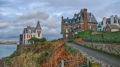 brown and white concrete building under cloudy sky during daytime