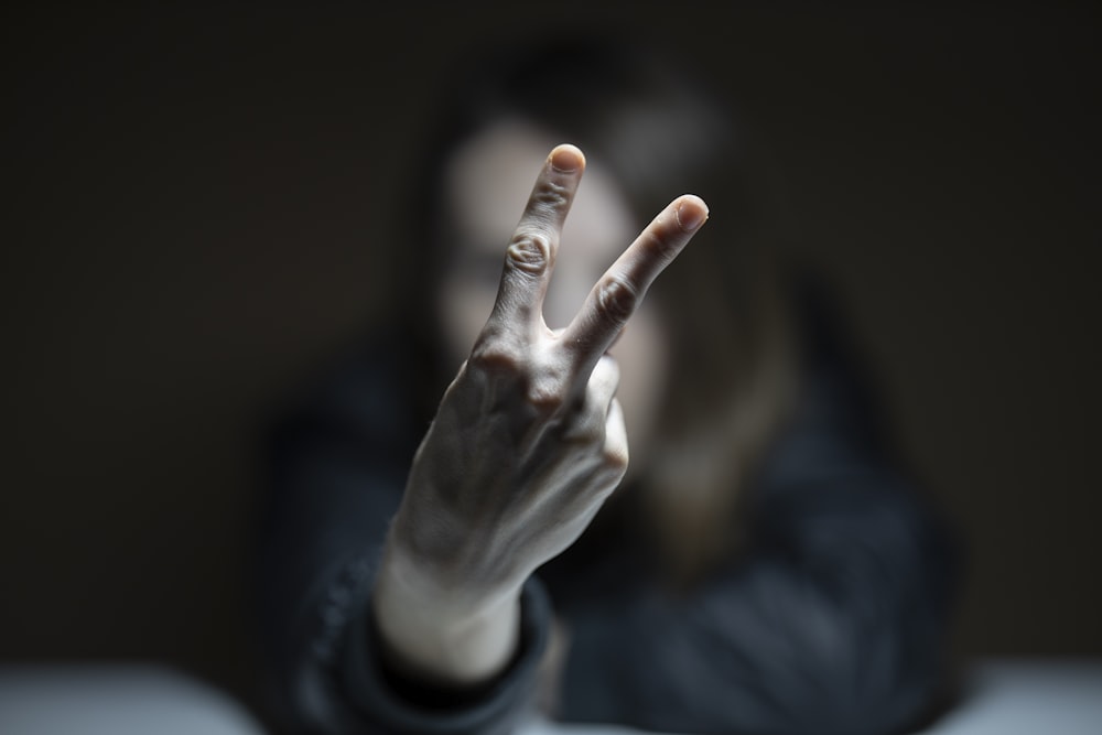 person in black long sleeve shirt showing right hand