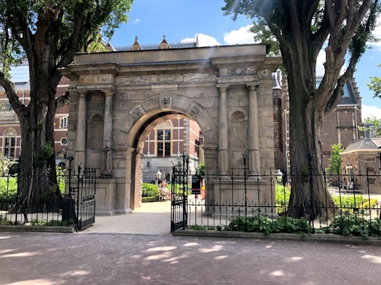 black metal gate near trees during daytime in Rijksmuseum Netherlands