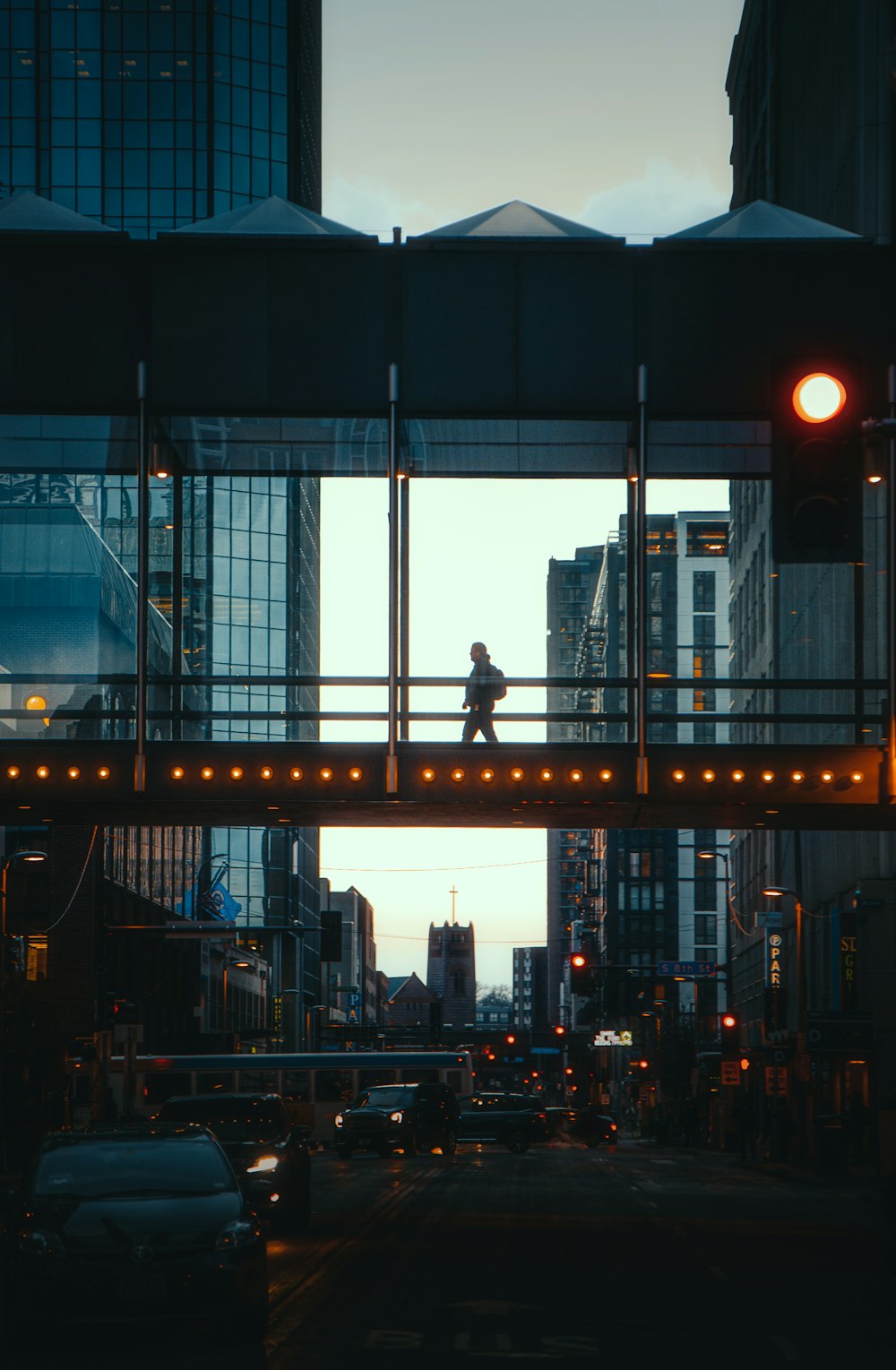 man in black jacket standing on bridge during night time