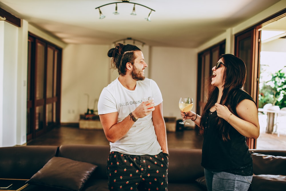 man in white crew neck t-shirt and woman in blue and white floral dress