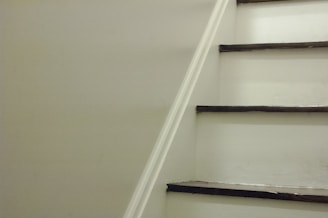 Before and after comparison of a staircase transformed with elegant white paint