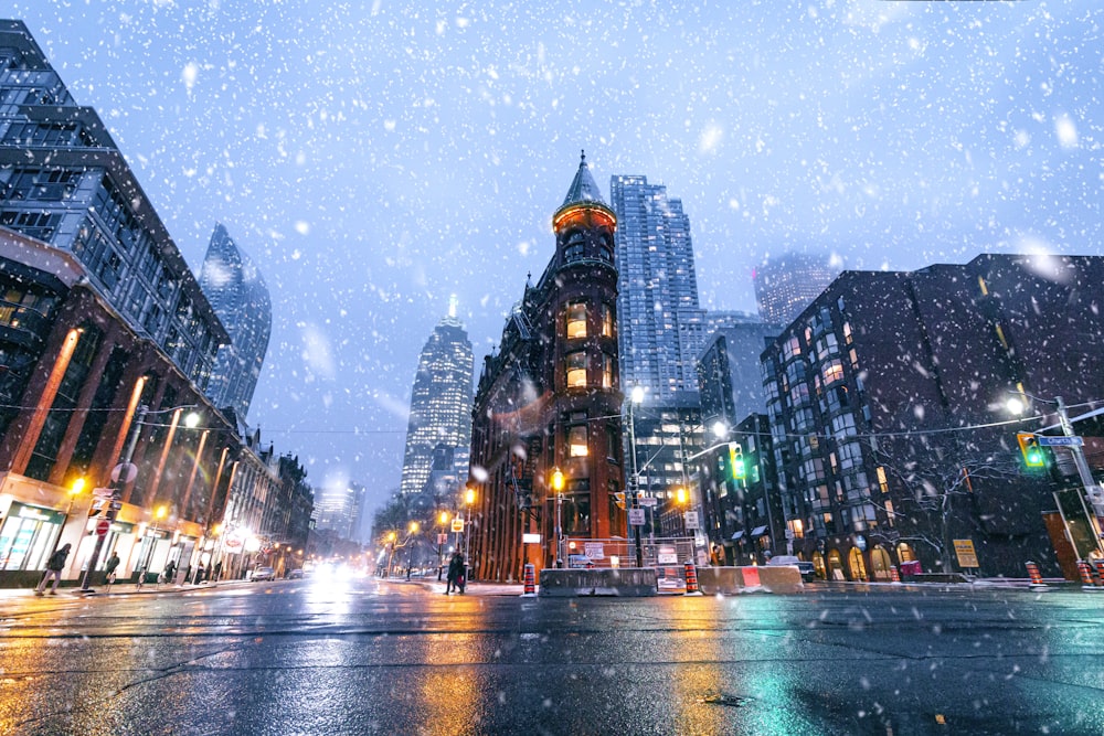 city buildings with lights turned on during night time