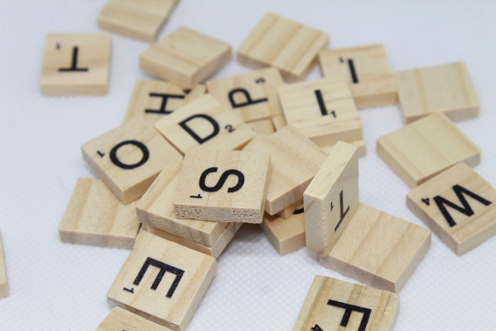 brown wooden letter blocks on white surface