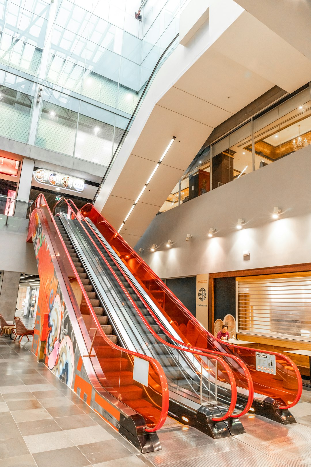 white and red escalator inside building