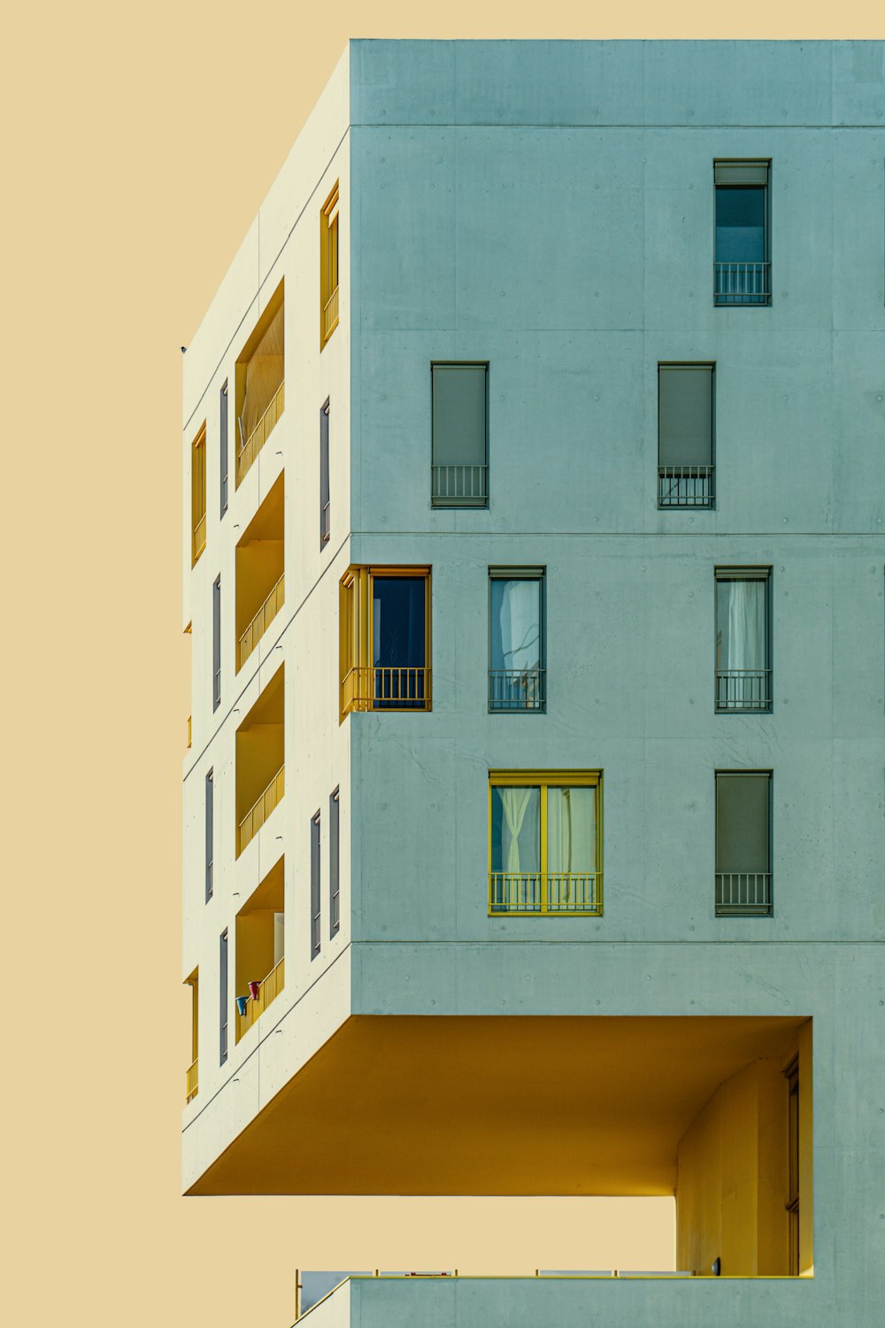 white concrete building with blue windows