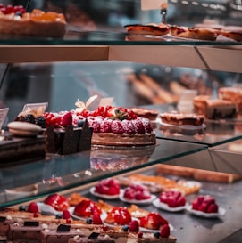 strawberry and blackberry on clear glass display counter