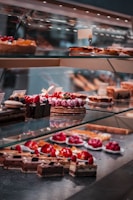 strawberry and blackberry on clear glass display counter