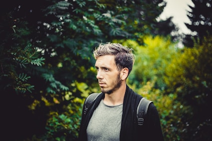 man in gray crew neck shirt and black backpack