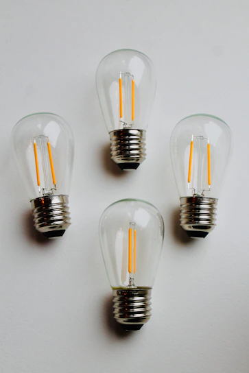 Various automotive light bulbs arranged neatly on a minimalist black background