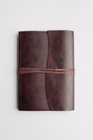 red leather long wallet on white table
