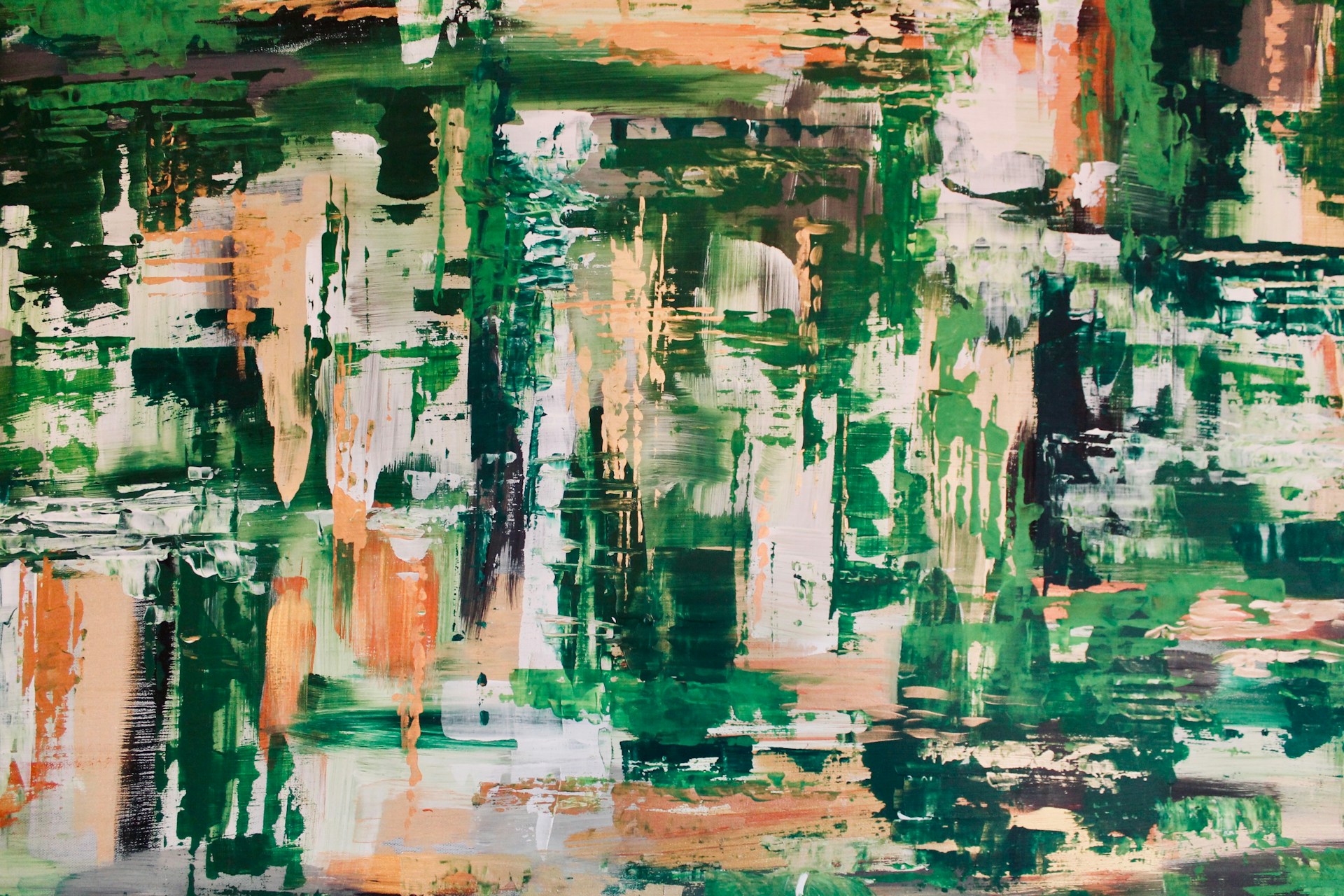An abstract painting featuring a mix of vibrant colors with dominant green hues, interspersed with patches of orange, white, and black. The strokes appear random yet structured, creating a dynamic texture that evokes movement.