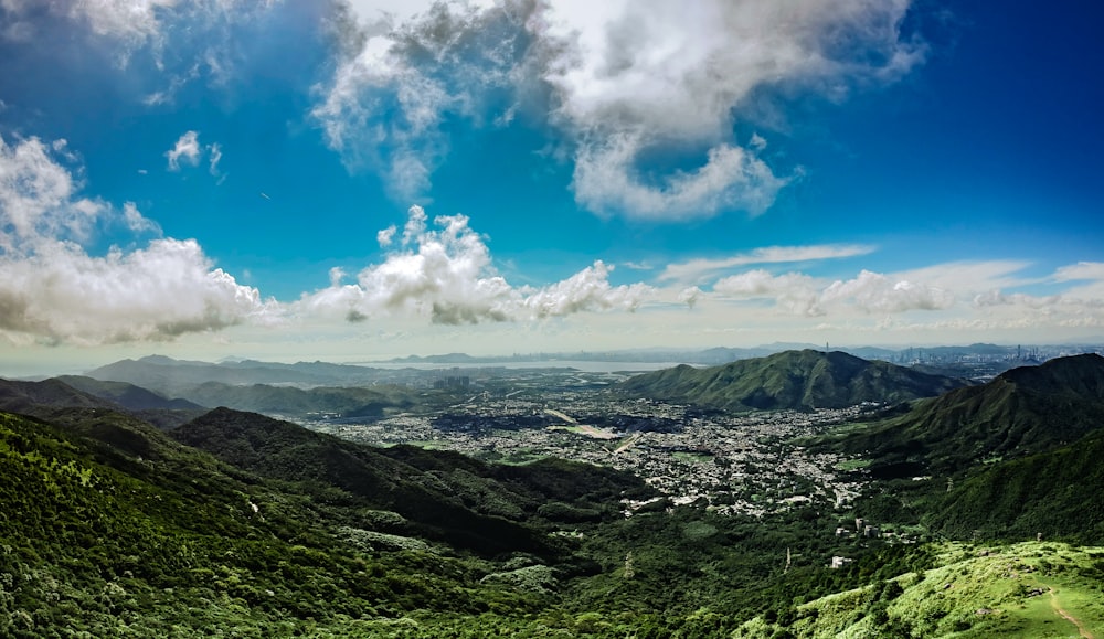 green mountains under blue sky and white clouds during daytime