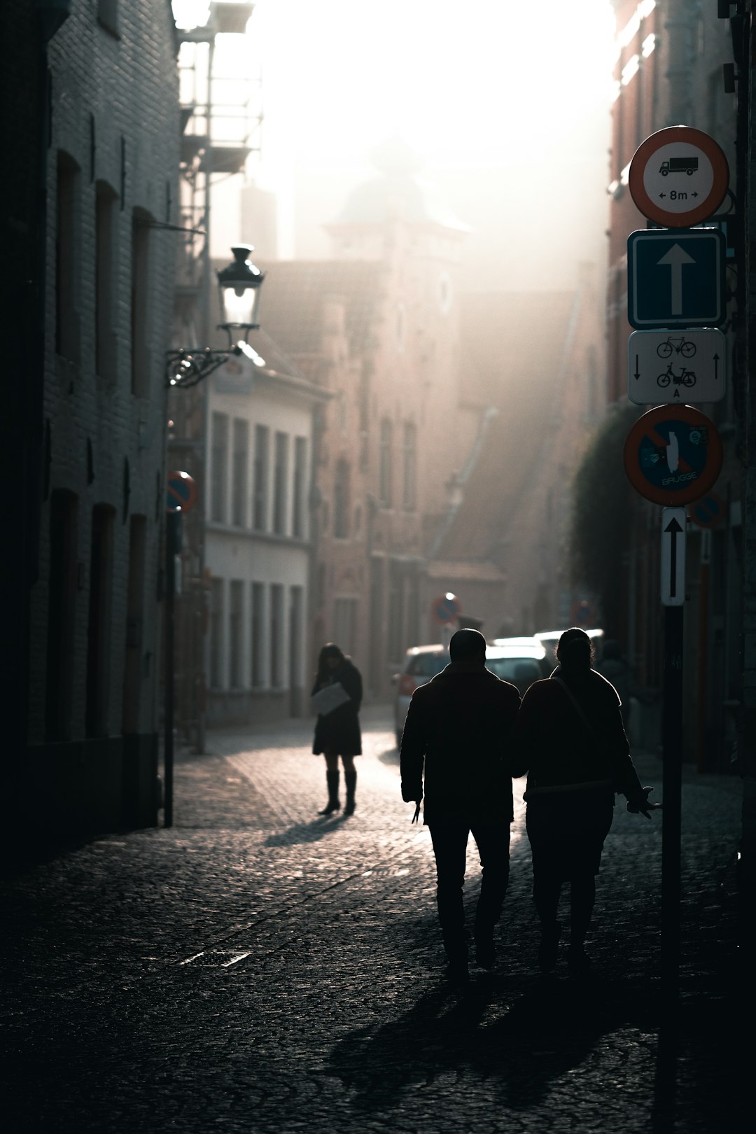 man and woman walking on sidewalk during daytime