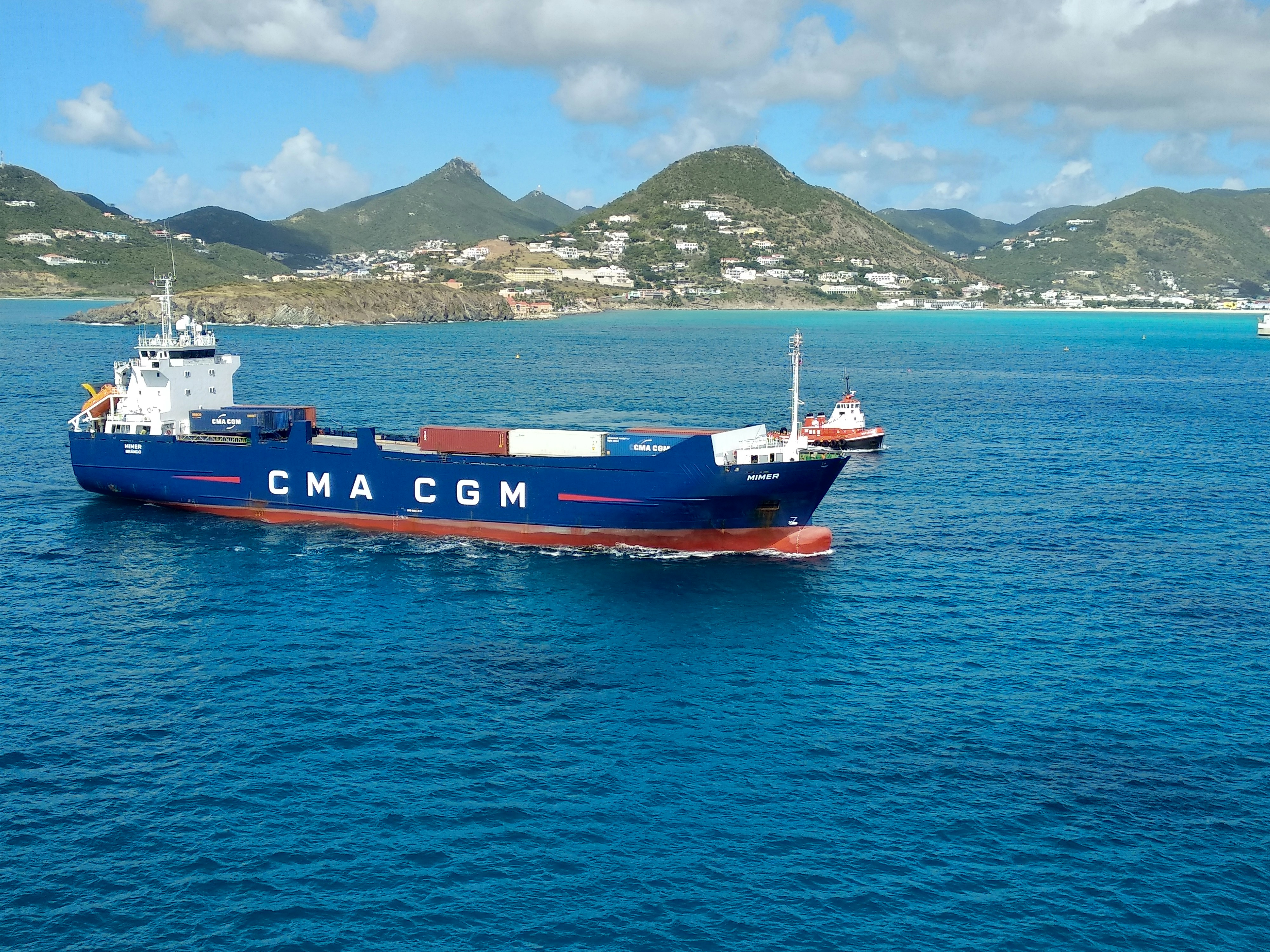 red and blue cargo ship on sea during daytime