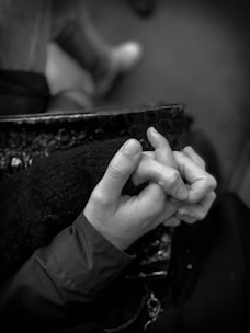 Close-up of hands intertwined, symbolizing connection and trust.