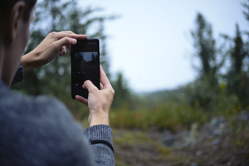 person holding black samsung android smartphone