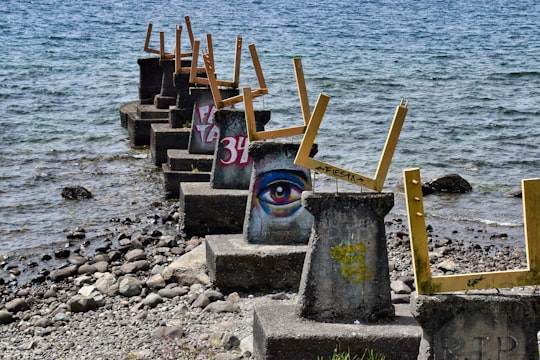 gray concrete blocks on beach during daytime in Puerto Varas Chile