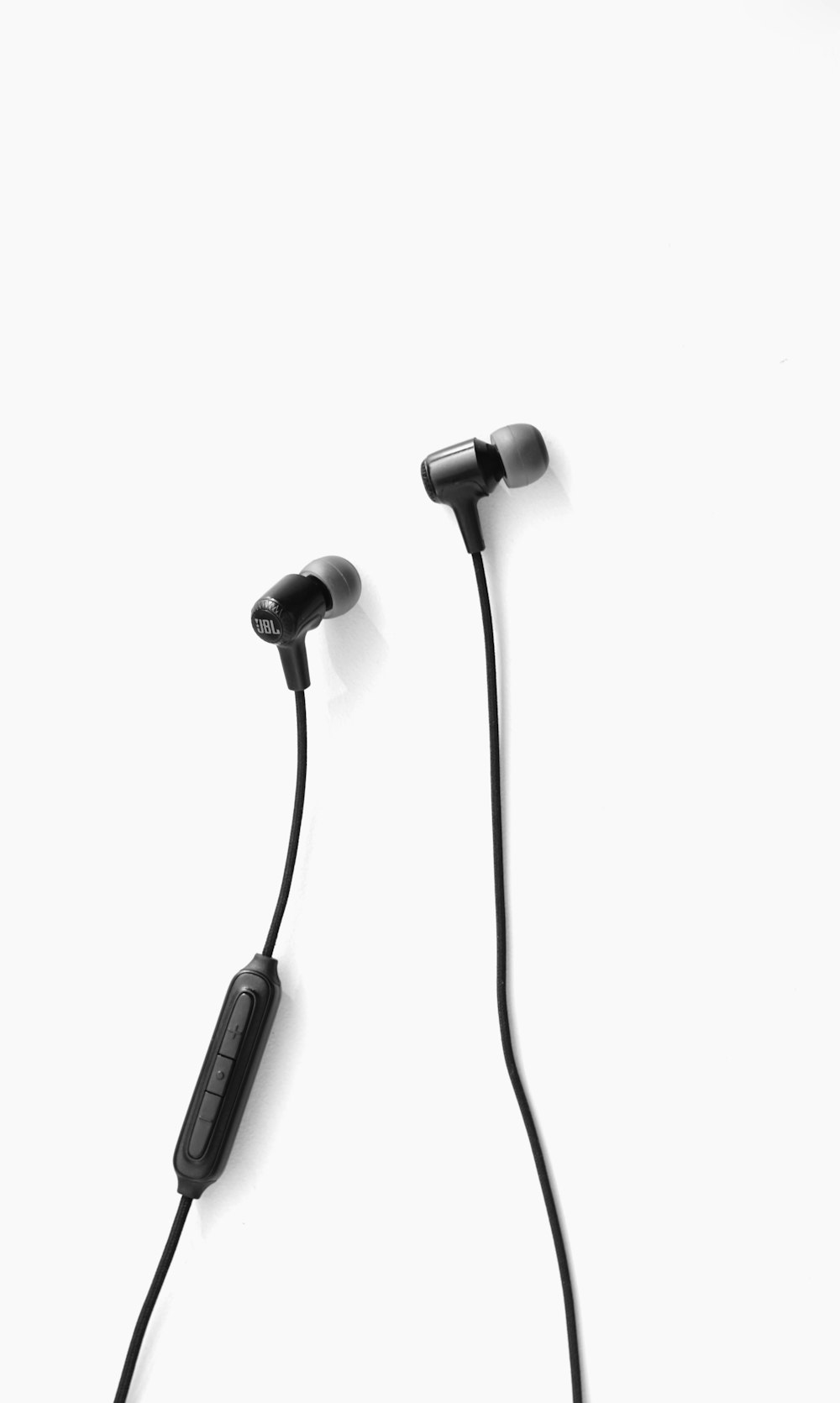 black earbuds on white background