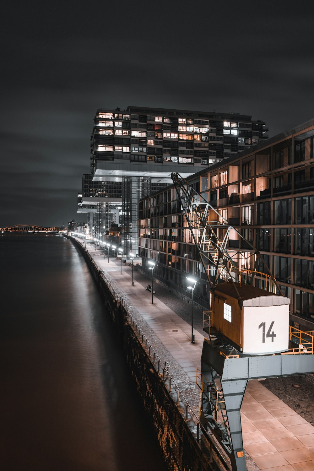 brown and white concrete building beside river during night time