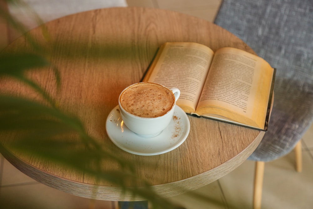 white ceramic cup on white ceramic saucer on brown wooden table