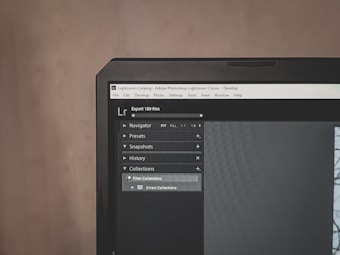 A computer monitor displays Adobe Lightroom Classic with a visible navigation panel on the left side. The interface includes options like Navigator, Presets, Snapshots, History, and Collections. A dark theme is applied, with a close-up focus on the top part of the screen, emphasizing the menu options and the title bar.