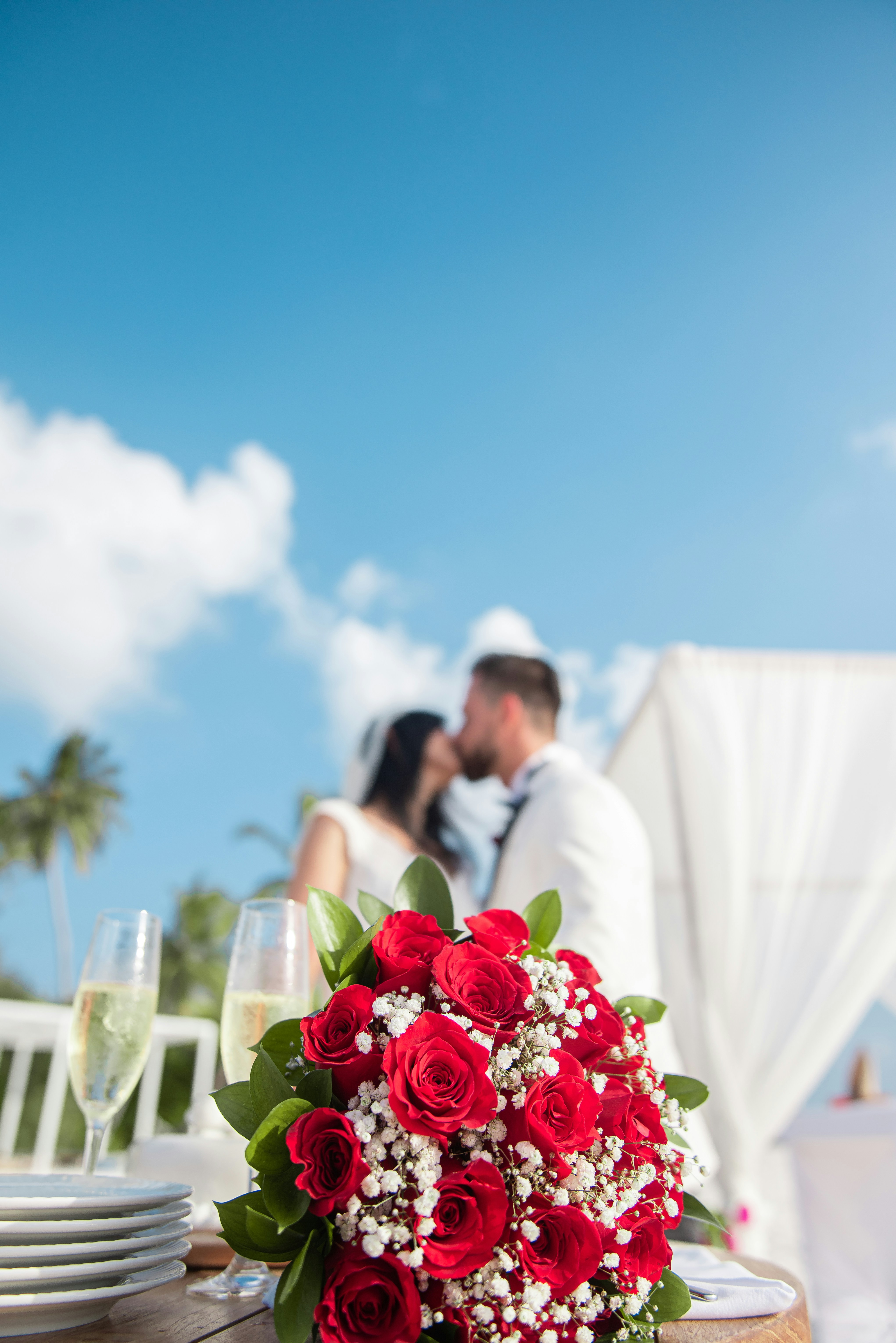 Woman In White Wedding Gown Holding Bouquet Of Red Roses Photo Free Human Image On Unsplash