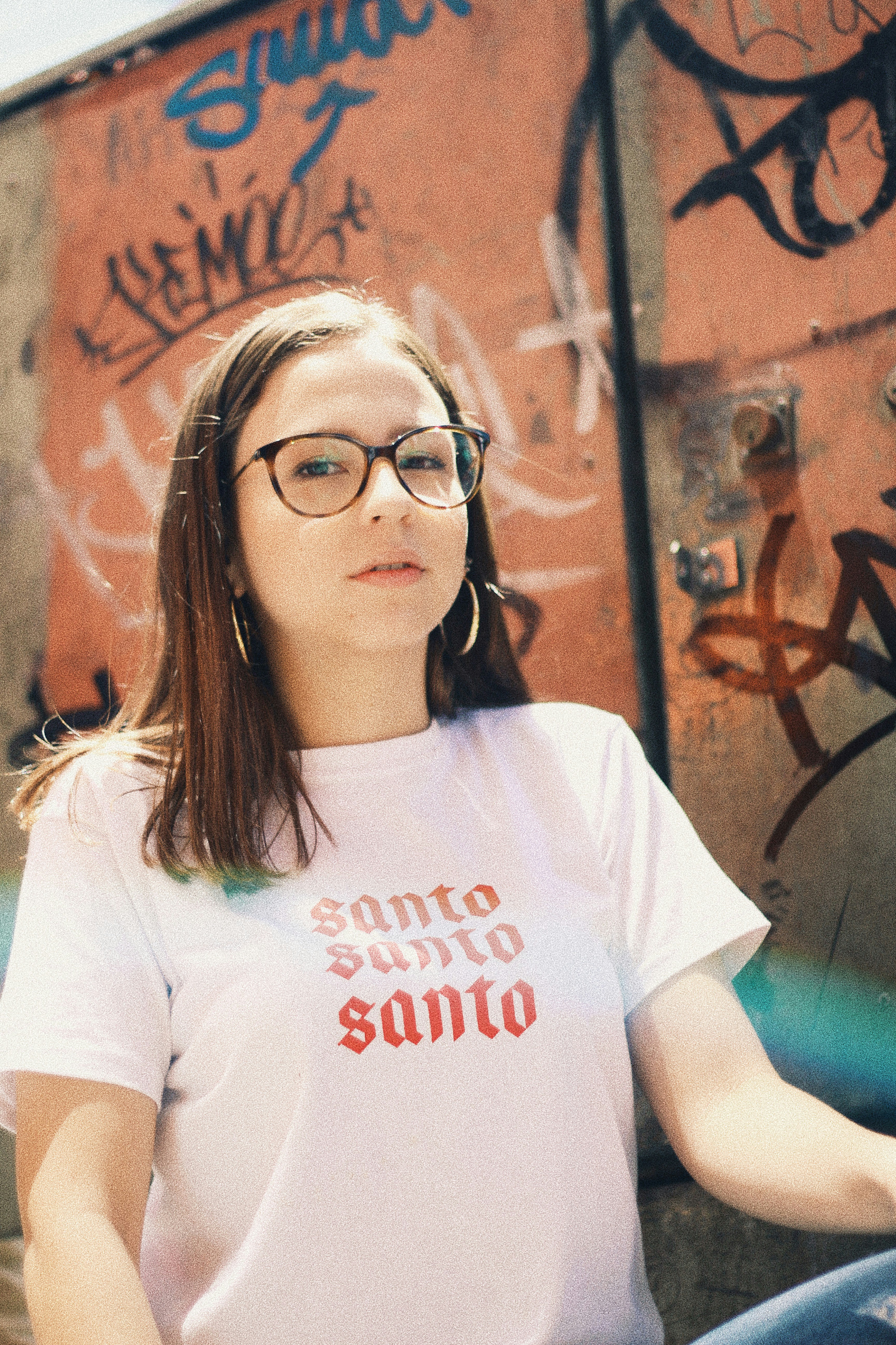 woman in white crew neck t-shirt wearing black framed eyeglasses
