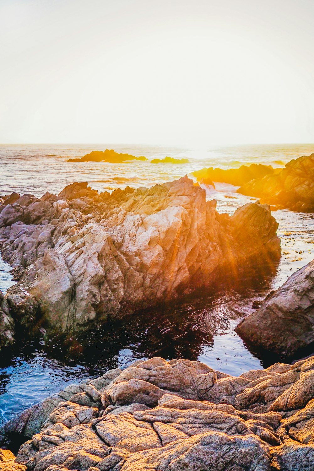 brown rock formation on sea during daytime