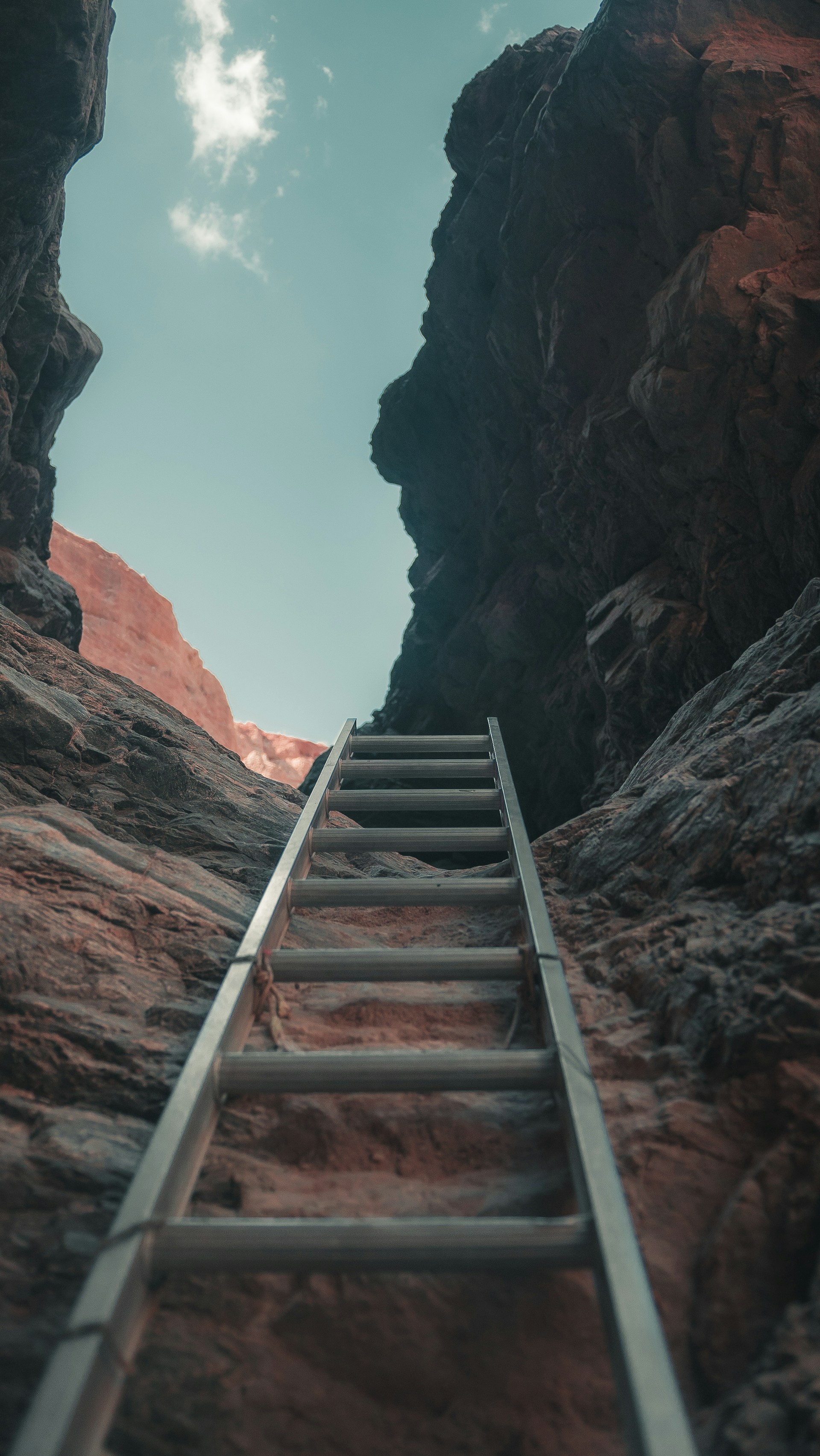 brown wooden staircase on brown rocky mountain during daytime