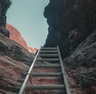 brown wooden staircase on brown rocky mountain during daytime