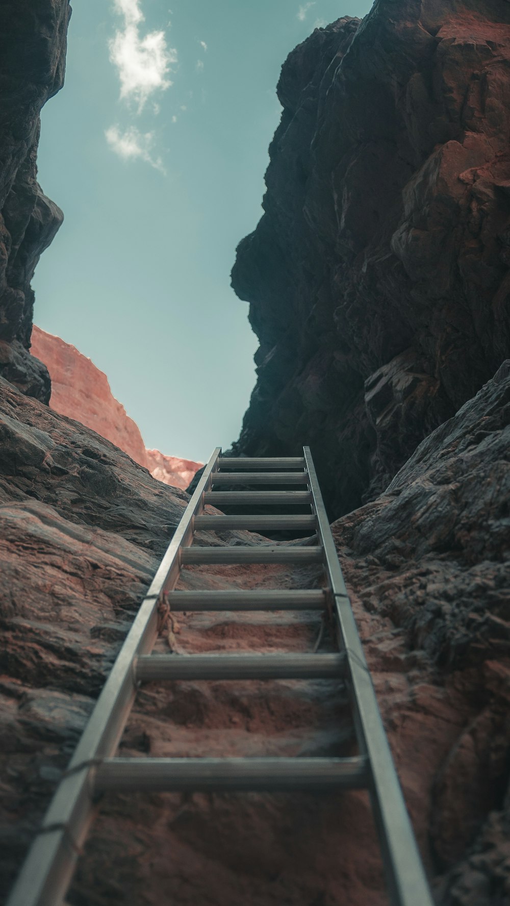 brown wooden staircase on brown rocky mountain during daytime