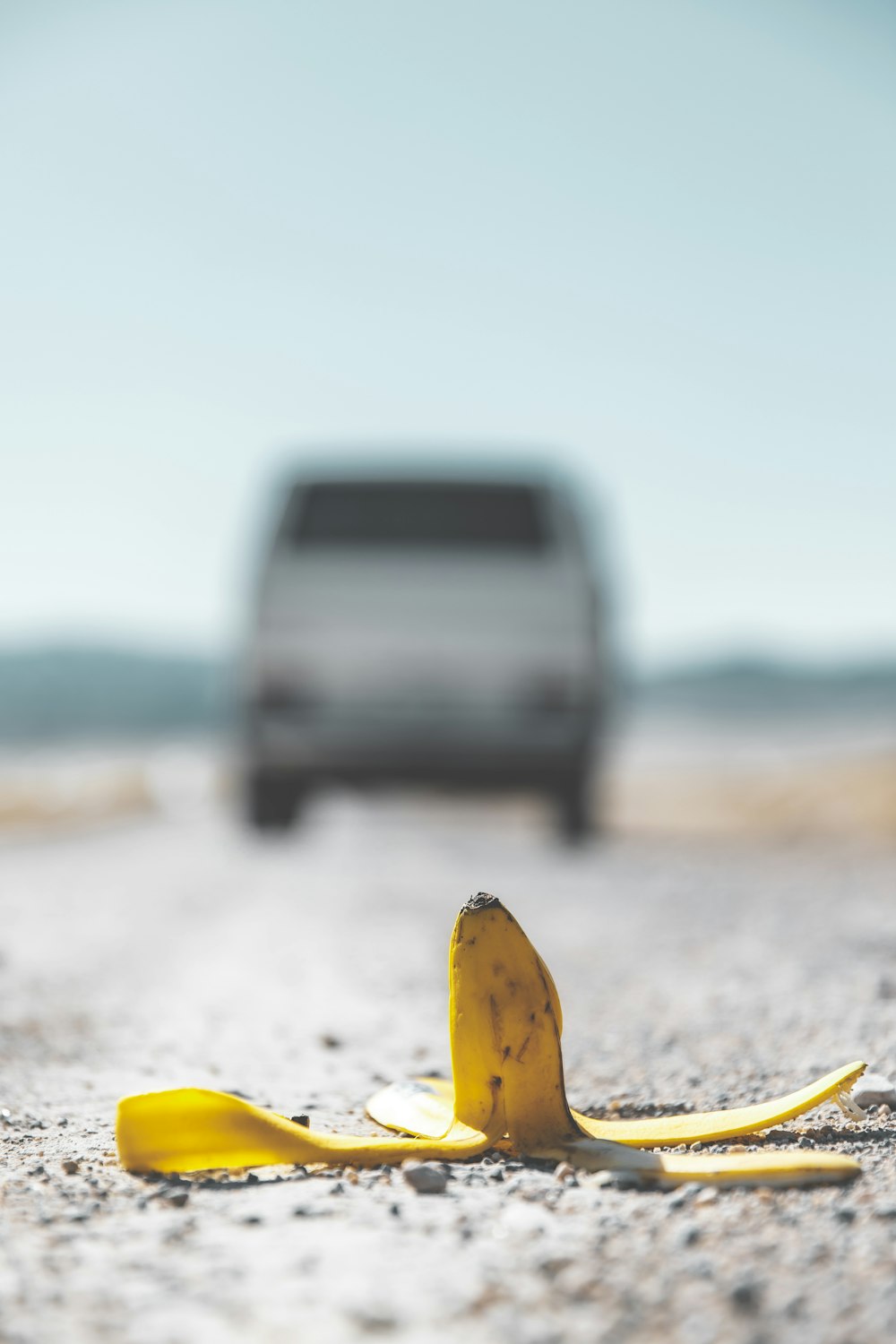 yellow banana peel on white sand during daytime