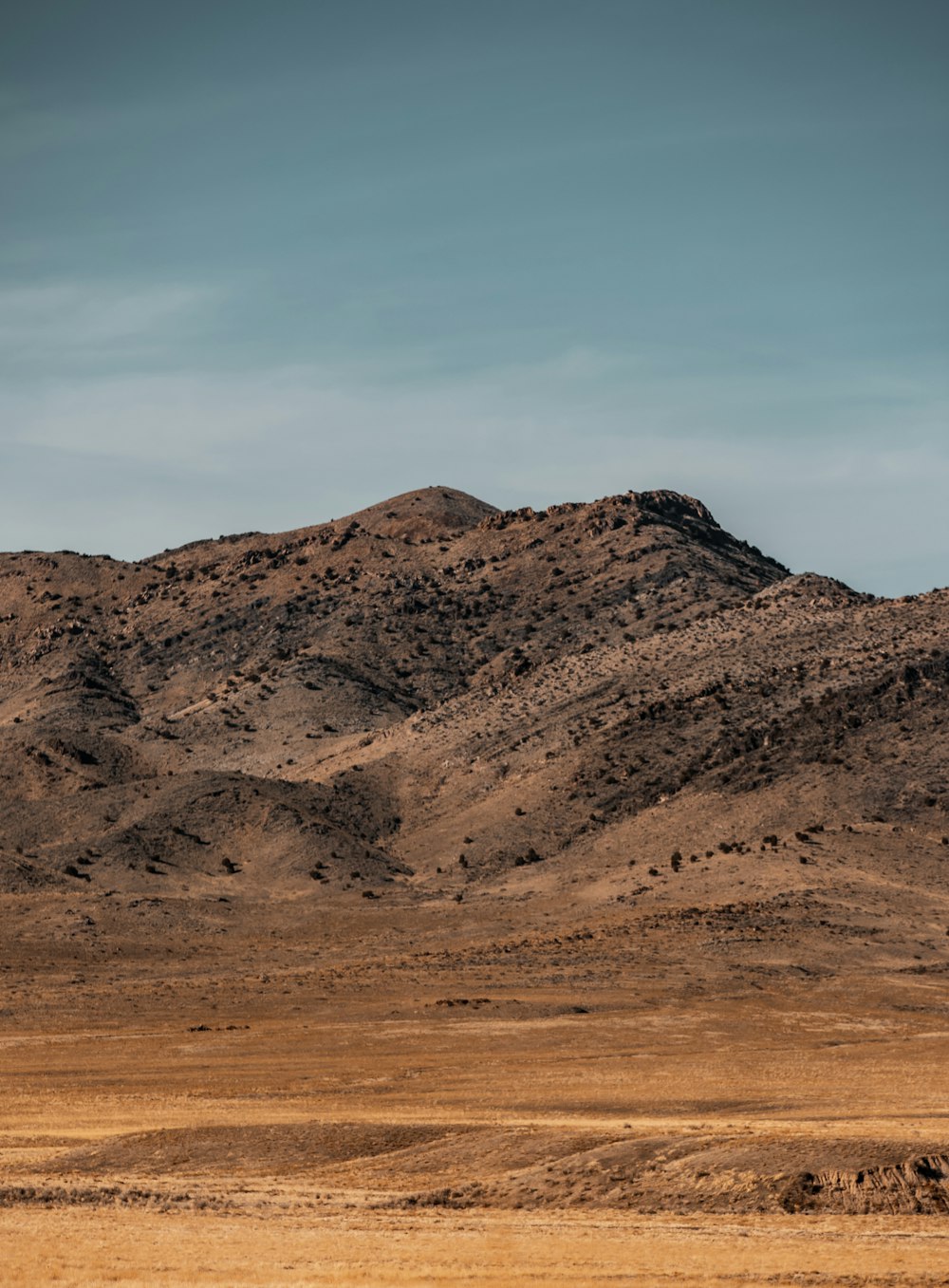 brown mountain under blue sky during daytime