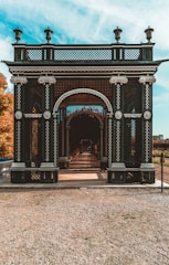 Flexible trellis elegantly framing a garden pathway with climbing plants.