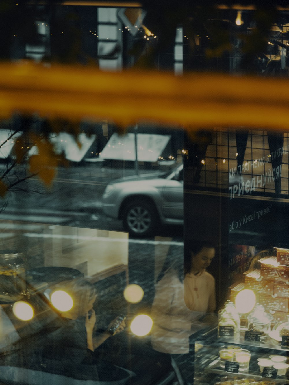 man in white dress shirt standing beside glass window