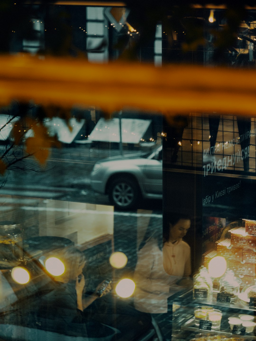 man in white dress shirt standing beside glass window