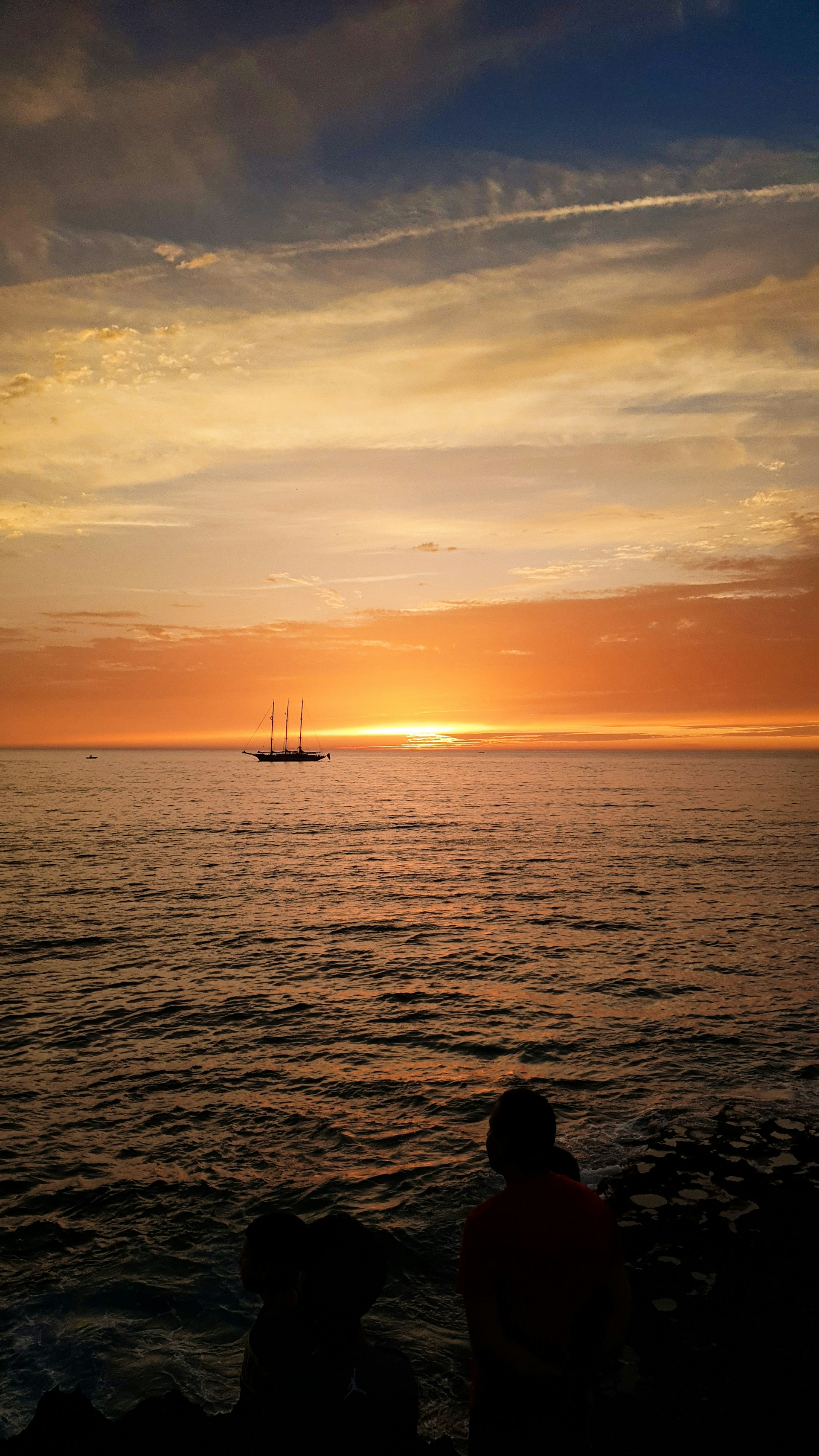 silhouette of boat on sea during sunset
