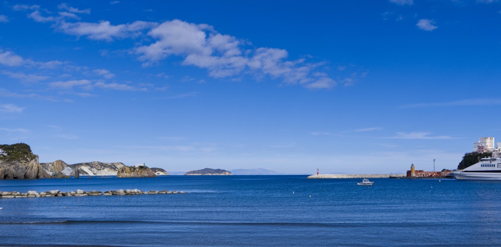 white ship on sea under blue sky during daytime