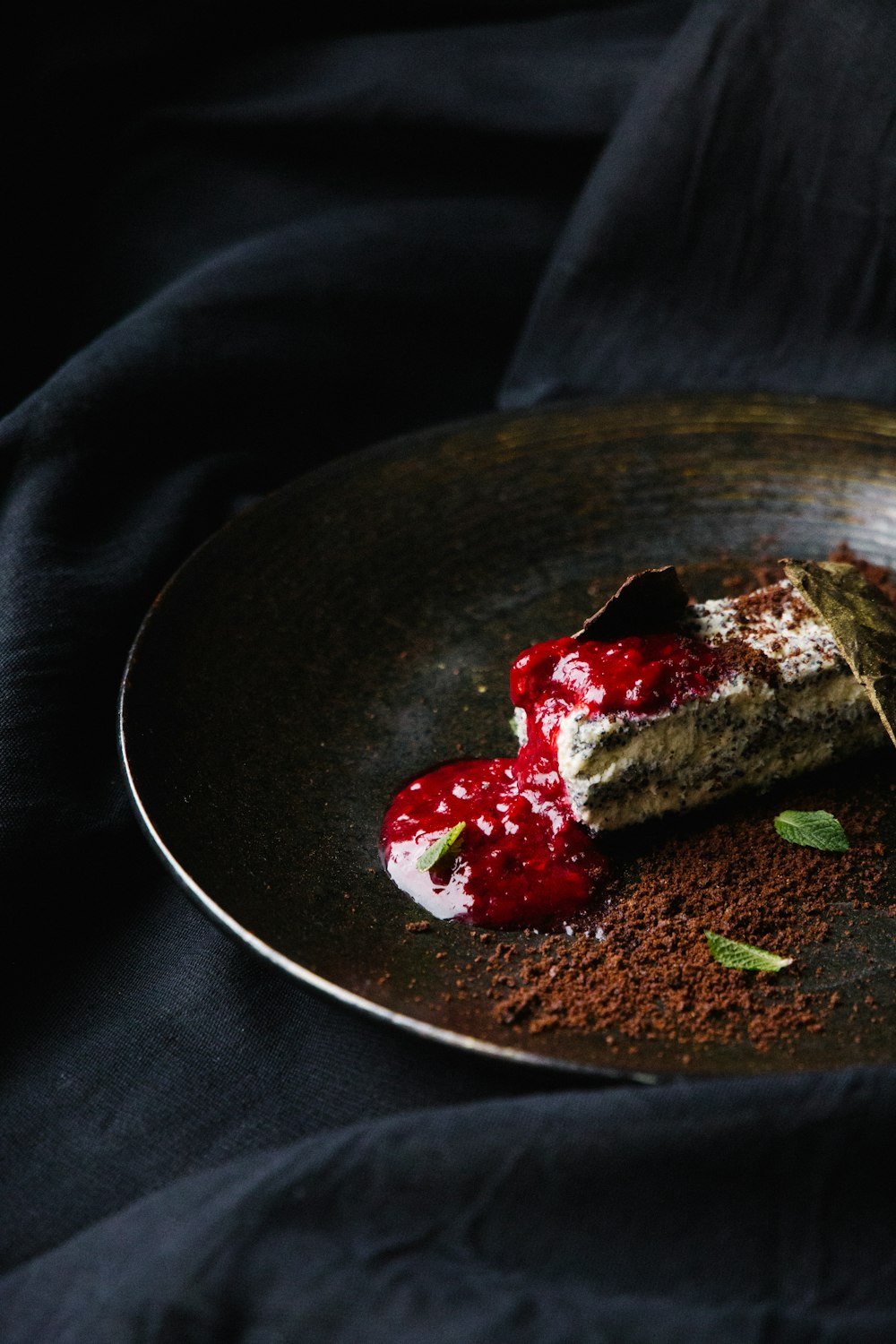 brown and green food on black ceramic plate